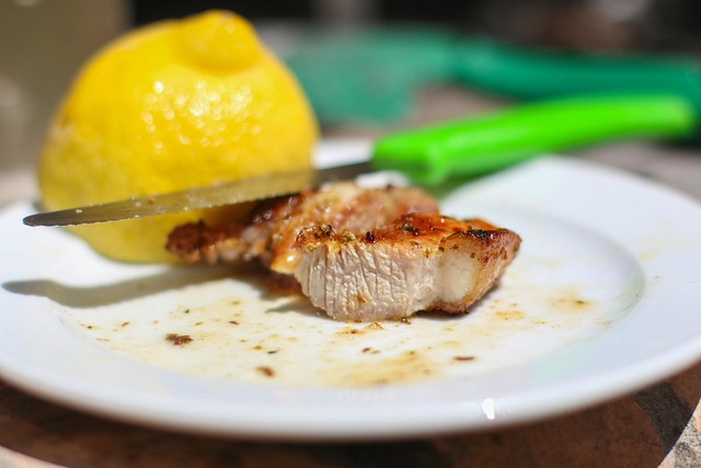 seared lion's mane mushroom steaks on a dark plate with herb butter and roasted vegetables